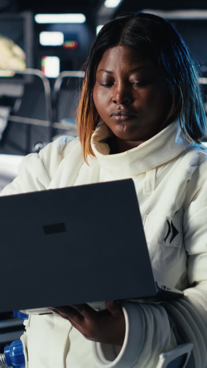 Vertical video Astronaut monitoring life support systems before stepping out of space station