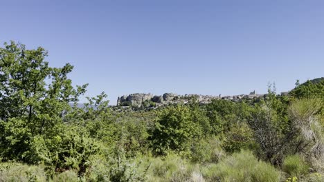 rocks protrude from a forest, standing alone in the french sun