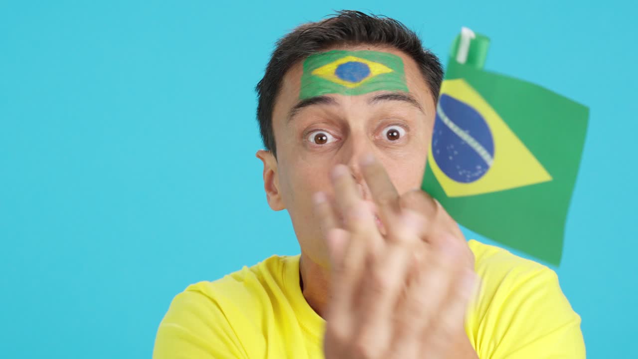Man with brazilian national flag upset with a football referee