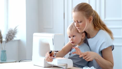 mother and child sewing together