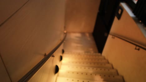 descending staircase with warm lighting and shadows