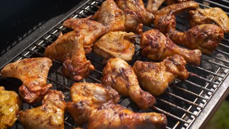 delicious chicken pieces frying on barbecue grill