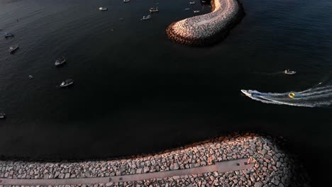 Luxury-Speed-Boat-On-High-Speed-Leaving-Harbor-During-Sunset-In-Albufeira,-Portugal