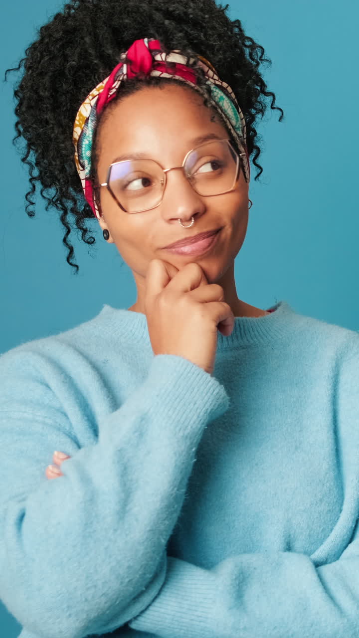 Thoughtful Young Woman Looks Up and Smiles at Camera
