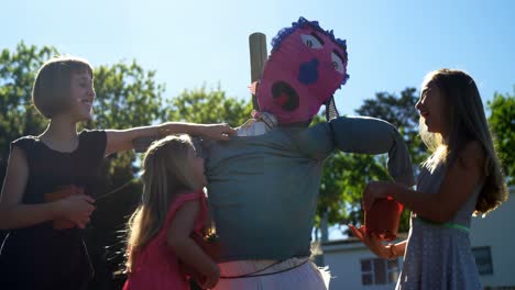 girls playing with scarecrow in the field 4k