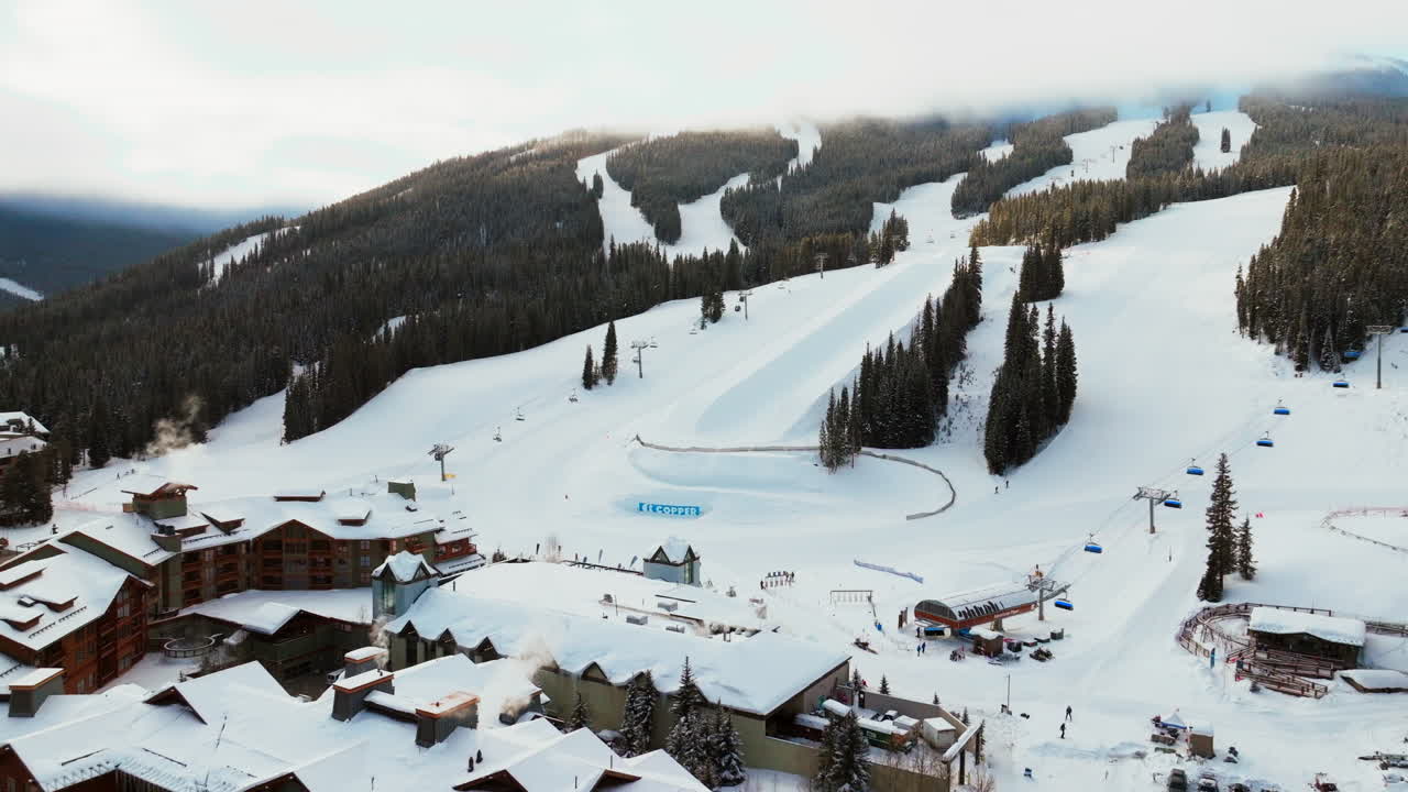 sun foggy cloud layer winter snowy early morning sunrise aerial drone Copper Mountain Colorado ski resort i70 Eagle Flyer lift center village snowboarding half pipe Ikon Epic pass backwards