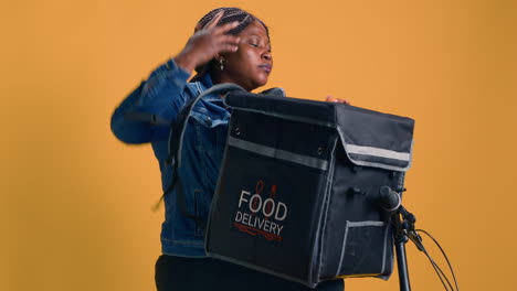 woman collects takeout from delivery bag