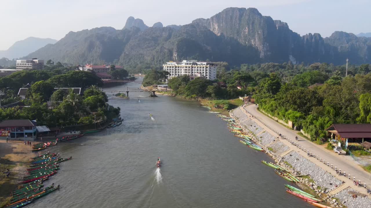 Cảnh quay từ trên không bay qua sông Nam Song lúc bình minh tại Vang Vieng với những chiếc thuyền đi qua