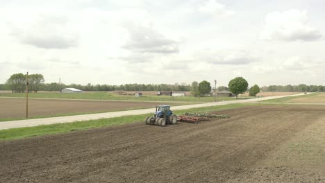 Farmer-in-tractor-cultivating-crop-in-field-take-5