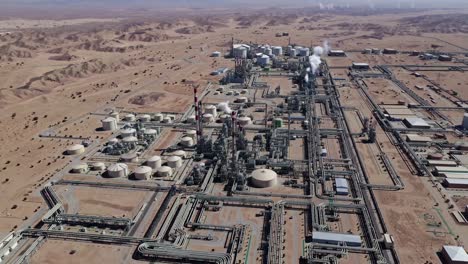 aerial view of a large oil refinery in a desert landscape