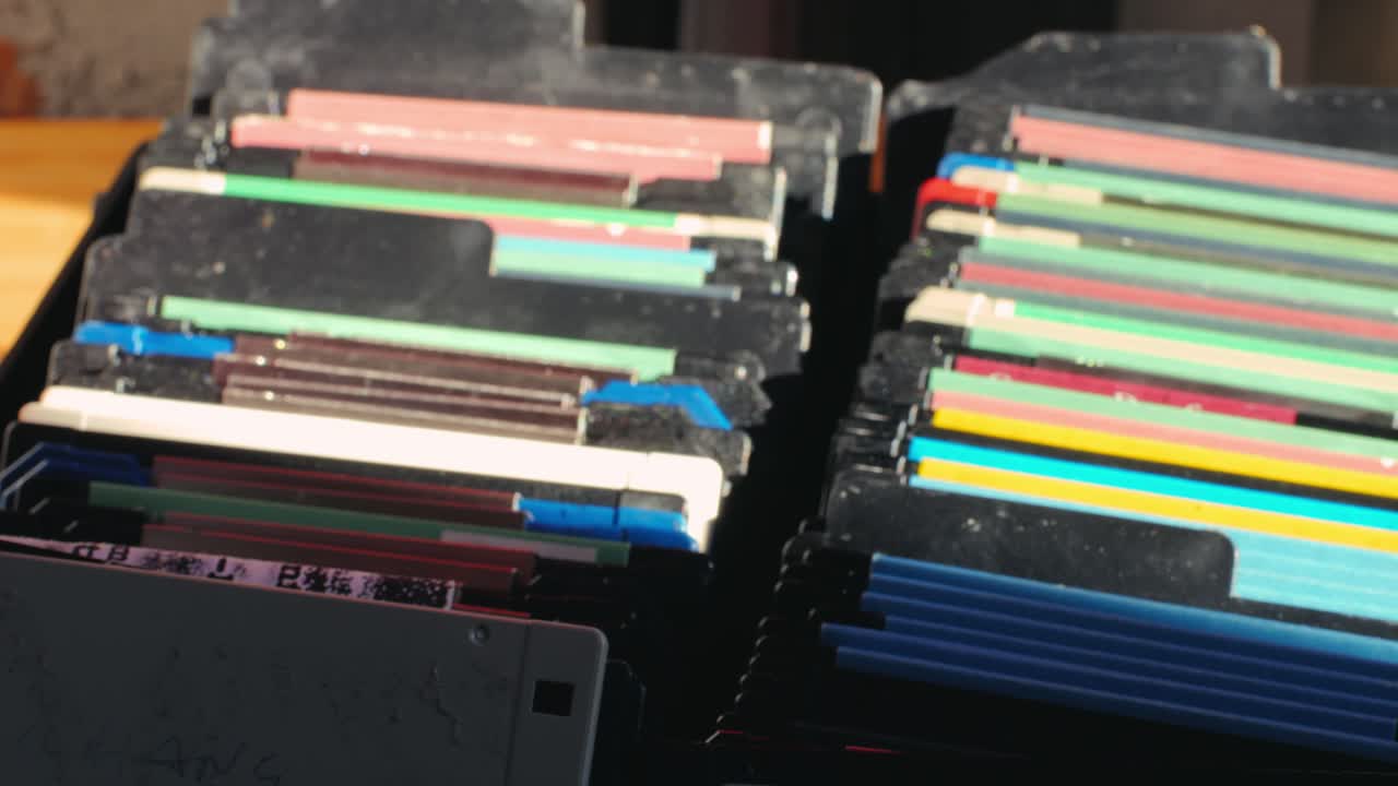 Using diskette for old computer. Music recorder, playing retro computer games. Vintage device for office, obsolete technology. . High quality 4k footage