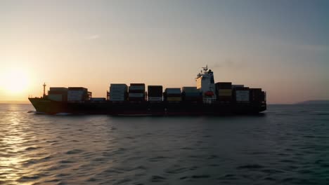 a majestic cargo ship sails through tranquil waters at sunset, silhouetted against a vibrant orange sky, showcasing the beauty of maritime transportation and global trade.