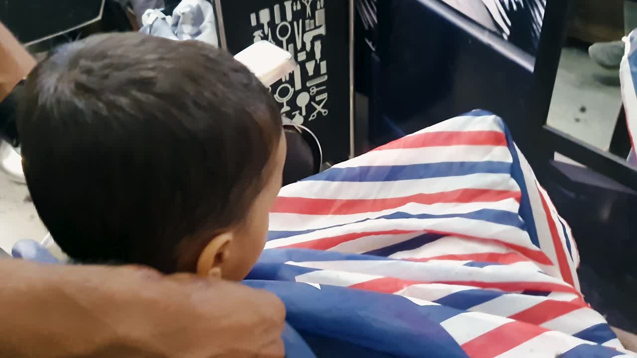 young boy getting ready for hair trimming indoor