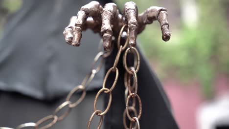 hand of a skeleton holding a chain