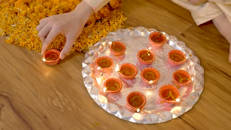 indian man decorating home for diwali