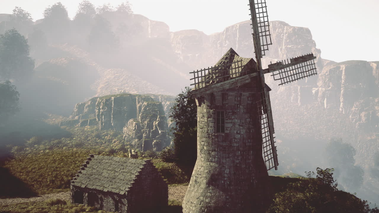Rustic windmill standing tall in the misty mountains during twilight hours