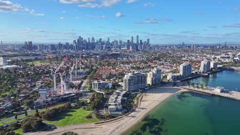 aerial view of port melbourne beachfront suburb with melbourne city skyline and active construction sites