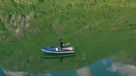 Woman-on-the-boat-catches-a-fish-on-spinning-in-Norway.