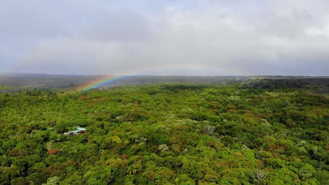 Lapso-De-Tiempo-Del-Arco-Iris-Formándose-Sobre-El-Bosque-Natural-Nativo-De-La-Isla-De-Hawaii-Y-La-Base-Del-Volcán-Kilauea-Con-Nubes-Moviéndose-Y-Proyectando-Sombras-Sobre-Los-árboles