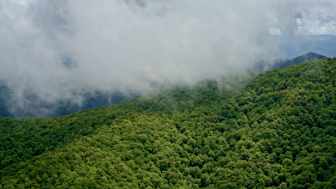 Flying over mist-laced peaks and rain-darkened valleys in the Smoky Mountains