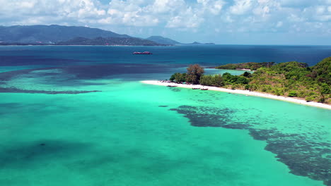 tropical island aerial view. camera flies over the shore and the beach of the tropical island