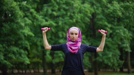 woman exercising in a park with a hijab