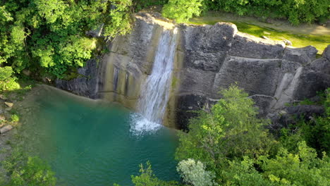 Medium-Wide-Dolly-Out-and-Top-view-Drone-shot-of-Slap-Veli-Vir-Waterfalls-and-Surrounding-Vegetation-during-the-day