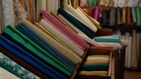 colorful rolls of fabric on display in a shop