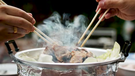 using chopsticks for bbq grilled pork or moo kra ta-1