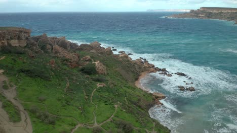 aerial: flying over il-qarraba paths and greenery on a cloudy bright day in winter