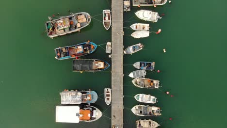 line of fishing boats on moored on a dock in algarve