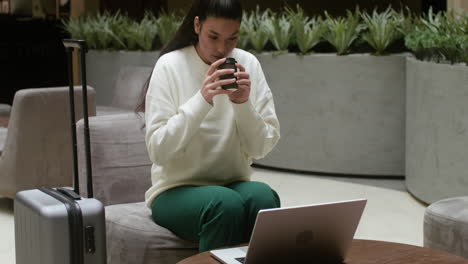 businesswoman working remotely from the hotel hall