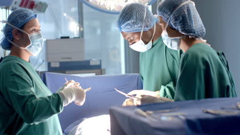 diverse female and male surgeons in masks passing surgical tools during operation, slow motion