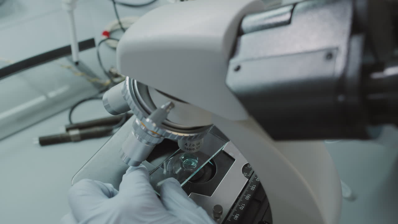 Close Up of Chemist Preparing Microscope Slide