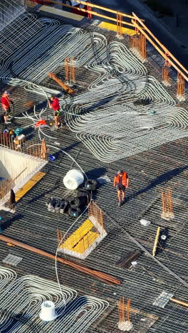workers install rebar for construction. workers are setting up a construction site, positioning rebar and tools to build the foundation during the day