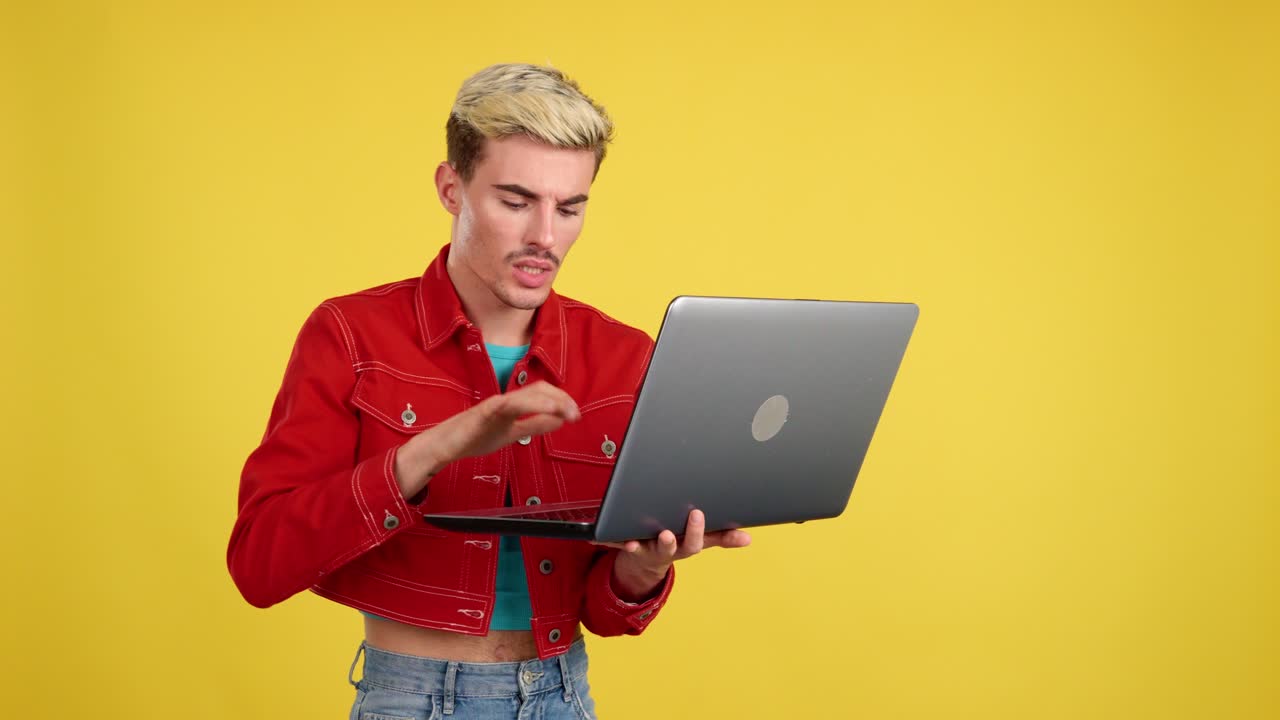 Man using laptop on yellow background