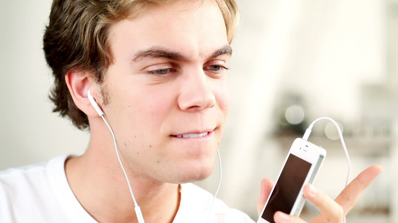 Young man listening to music at home