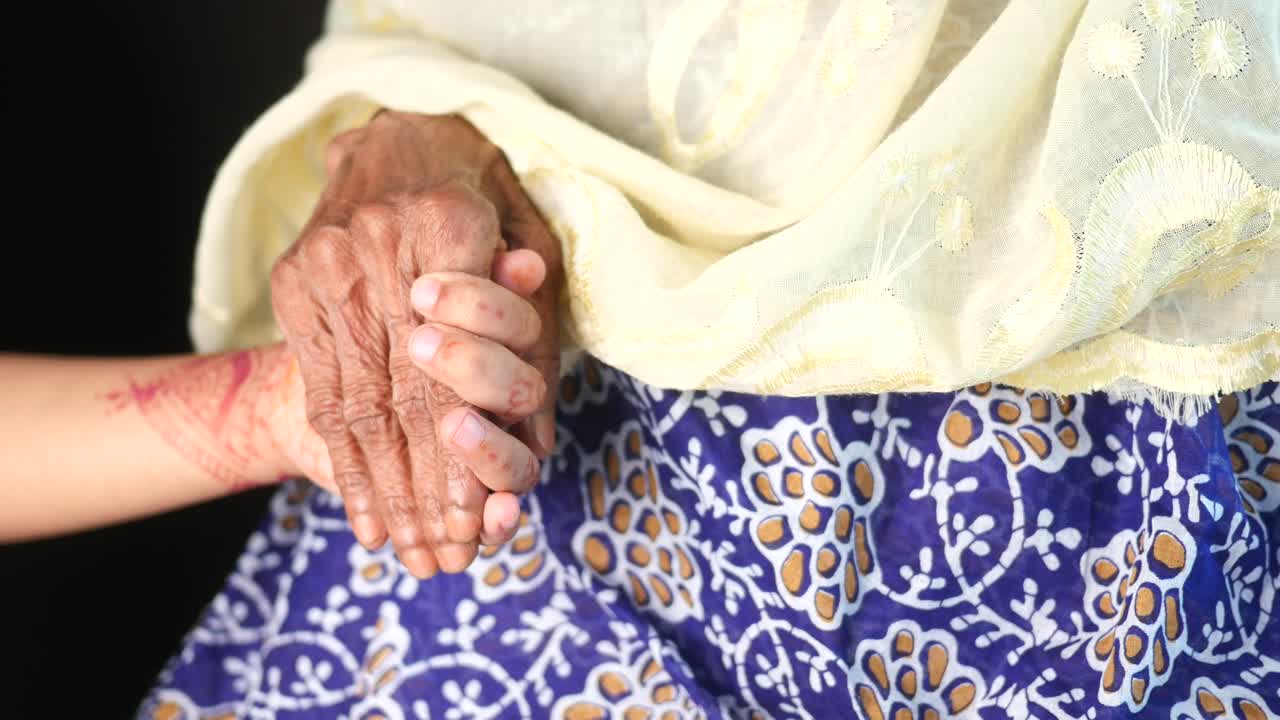 Touching Gesture of Care Between Young Girl and Elderly Woman