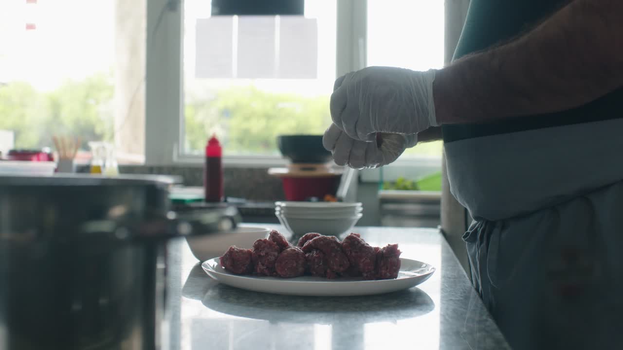 el cocinero está amasando la carne