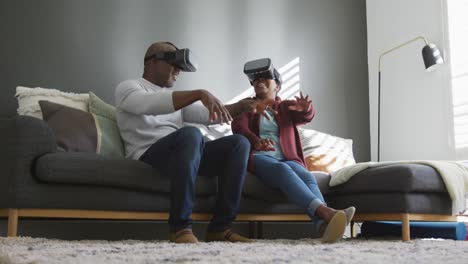 happy african american senior couple wearing vr headset and having fun