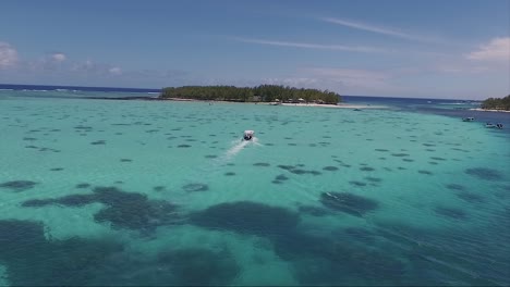 Coral-reef-area-of-the-island-isle-of-mauritius-with-speed-boats-moving-around-next-to-the-coastline