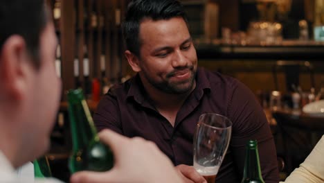 men talking and drinking beer in the pub