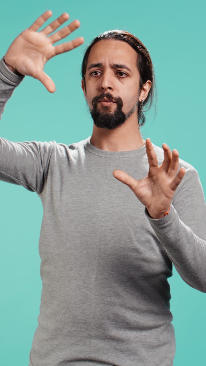Vertical video Man looking at AR hologram visualizations, doing swiping gestures