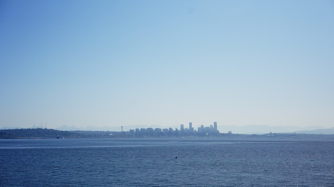 Boat tour around Seattle, Washington, showing the skyline, waterfront, and Puget Sound from the water. Ideal for travel, nautical, and cityscape footage