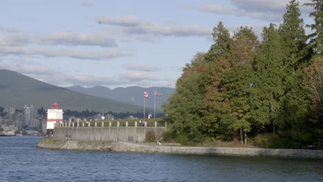 a typical day in stanley park, over viewing its mountains and surrounded by clear blue waters - medium shot