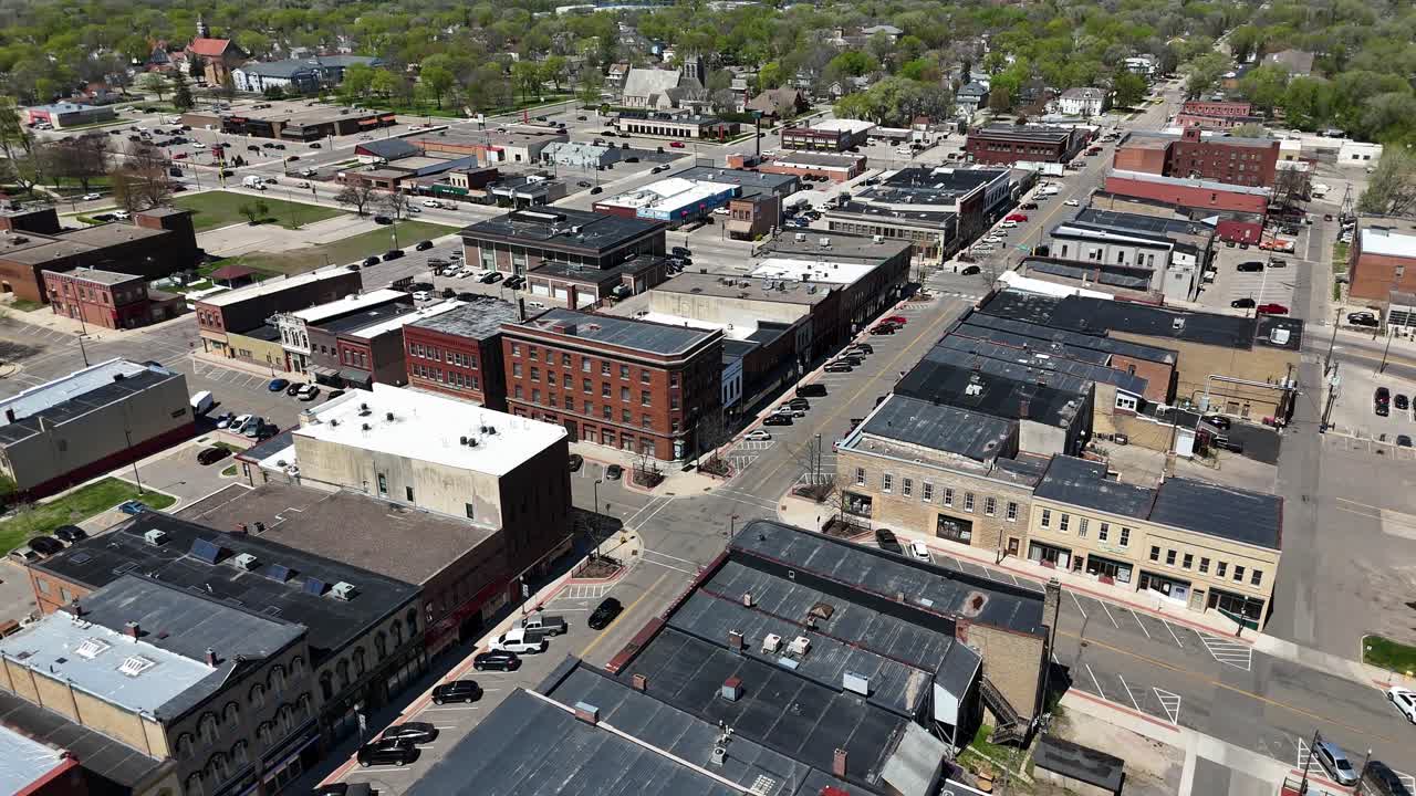 Drone Panning around downtown Faribault Minnesota, mid day early spring. Historic downtown with rustic buildings