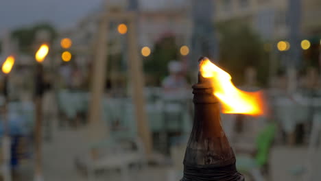 burning beach torch in the evening