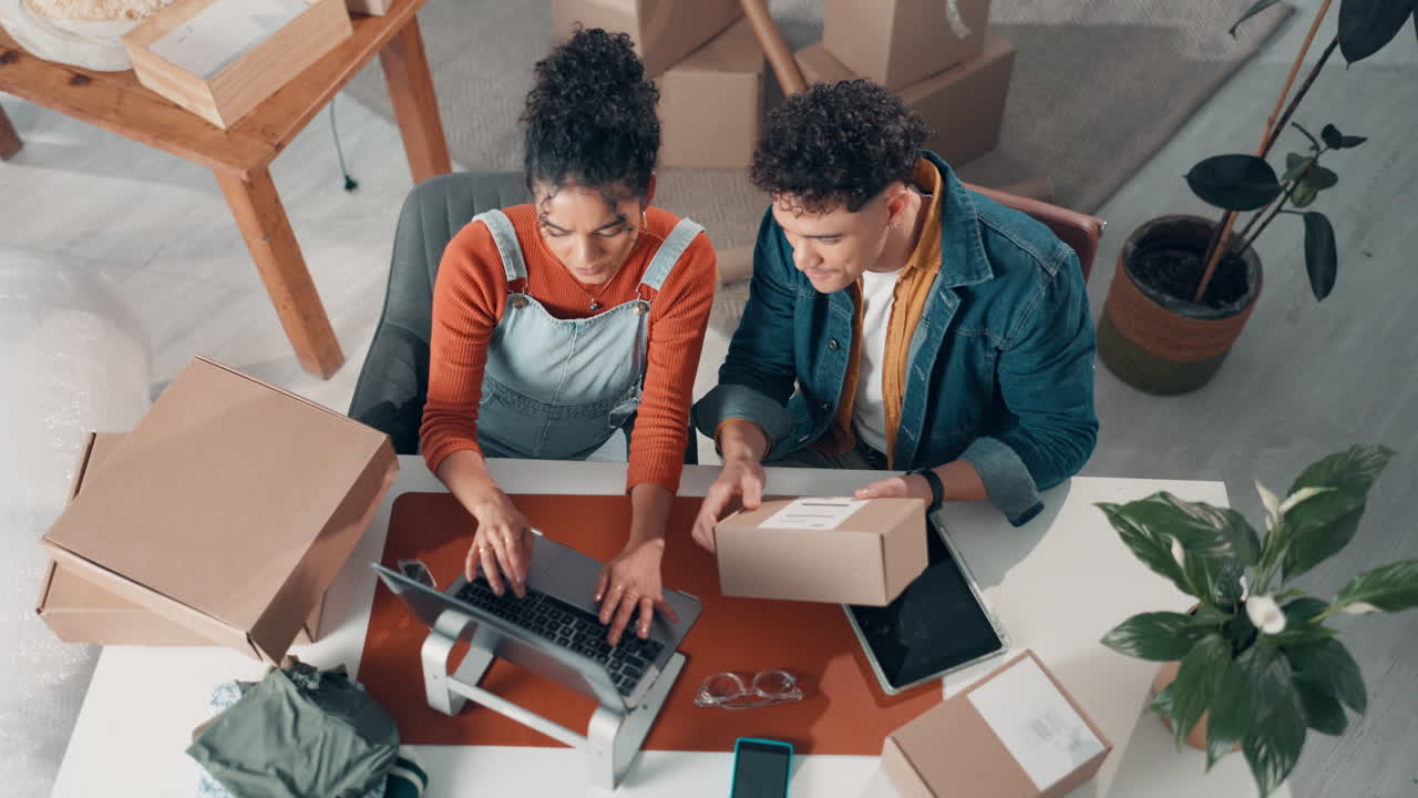Couple moving and using technology to organize boxes