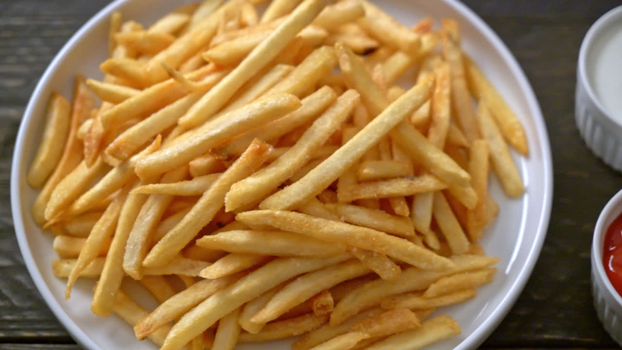 French fries or potato chips with sour cream and ketchup