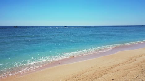 Sea-waves-sand-tropical-beach-clear-bright-blue-sky-summer-vacation-concept